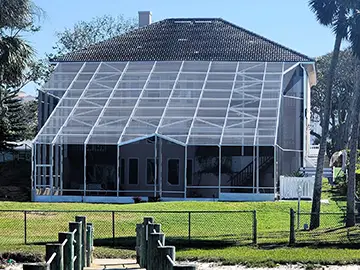White pool enclosure with sloping roof - Ormond Beach